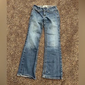 Ariat boot cut jeans. Size 27 short. Small stains in multiple locations.